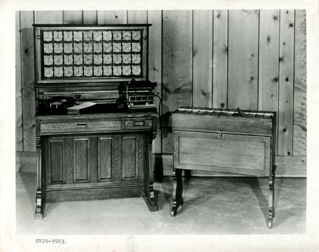 Image of a punch card and tabulating machine